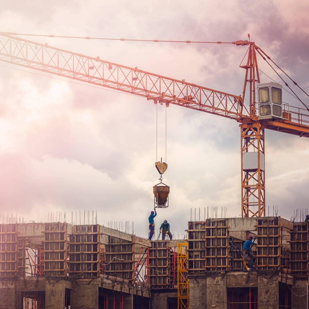 A crane is in the sky over some buildings.